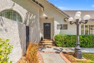 Doorway to property with stucco siding, a ceiling