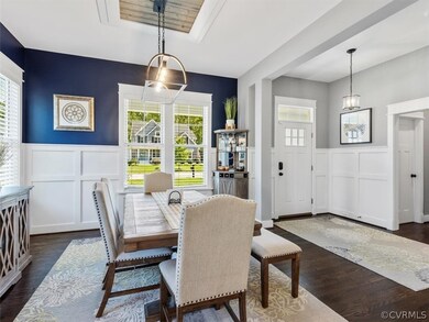 Off of the well appointed entry you’ll find the dining room w/ wainscotting and chandelier w/ decorative framing that is open to kitchen.