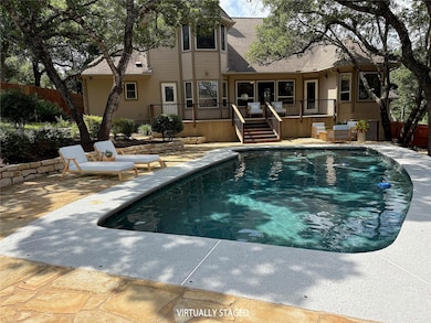 Outdoor pool with a deck and a patio