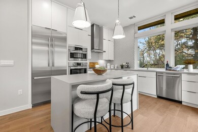 Kitchen with stainless steel appliances, white ca