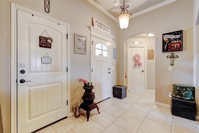 Entryway with light tile patterned floors and crow