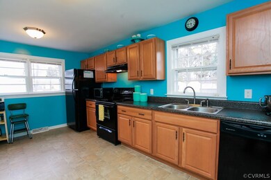 Large kitchen with lots of cabinets, counter space. The windows allow for lots of natural sunlight.