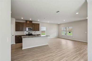 Kitchen featuring stainless steel appliances, ligh