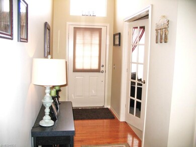Two story foyer with hardwood floors.