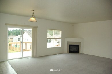 Family room with gas fireplace and sliding glass door to the newly built deck. 