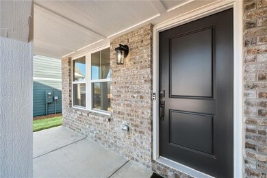 Entrance to property with brick siding