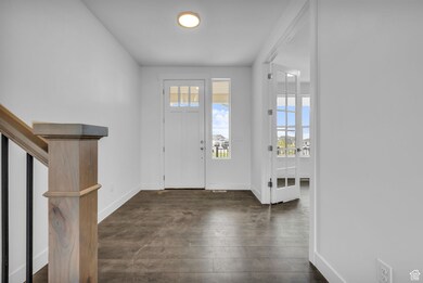 Open entry with adjacent french doors and office.