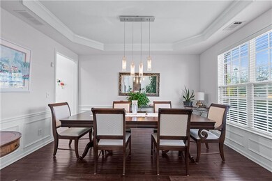 Dining space with dark wood-style floors, a tray c