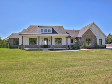 View of front facade with board and batten siding,