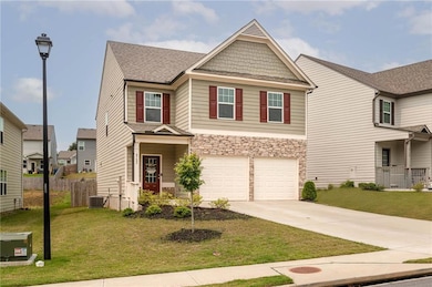 Craftsman inspired home featuring concrete driveway, a garage, central AC, stone siding, and a shingled roof