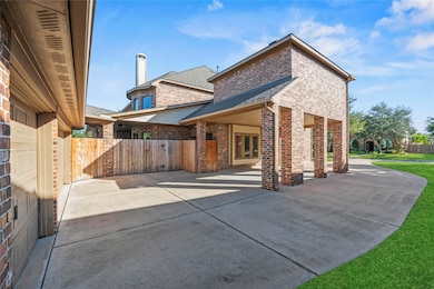 Another view of the Porte-Cochere and privacy fence leading to the backyard.
