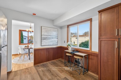 The sunny kitchen has a great view of the park-like backyard.