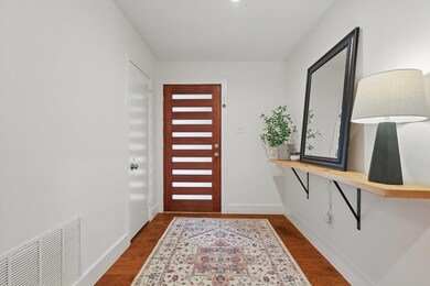 Entryway with dark wood-style flooring, baseboards
