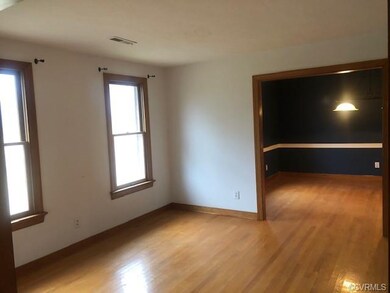 Standing in the foyer looking into the living room through to the dining room