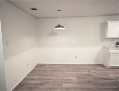 Unfurnished dining area featuring a wainscoted wa