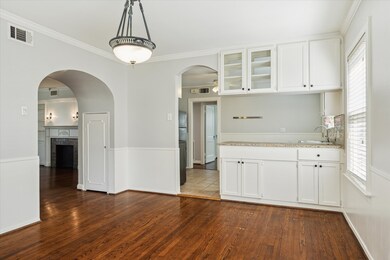 Dining room looking into kitchen. Notice the archw