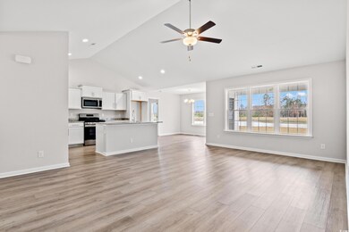 Unfurnished living room with high vaulted ceiling,