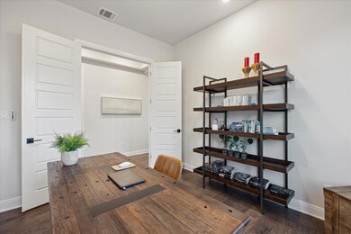 Home office featuring visible vents, baseboards, 