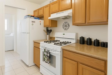 Kitchen featuring white appliances, under cabinet