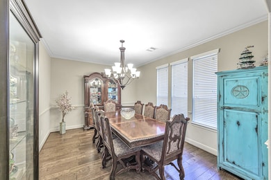 Formal dining room with wood flooring