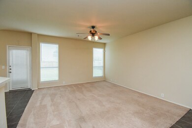 This is a spacious living room with neutral walls