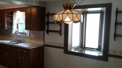 Dining area with bay window and tiffany style ligh