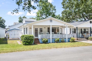 View of front of home with a shed, a porch, and a 