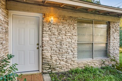 Doorway to property featuring stone siding