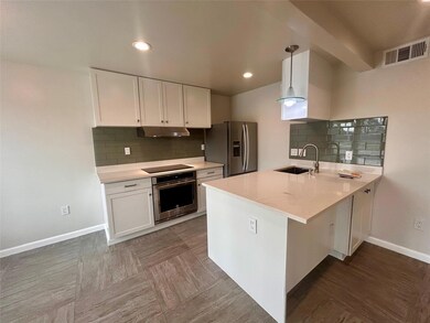 Kitchen featuring appliances with stainless steel
