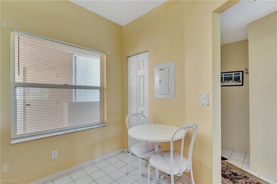 Dining room featuring electric panel, light tile patterned floors, and a textured ceiling