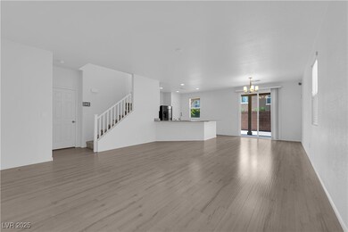 Unfurnished living room featuring a chandelier, st