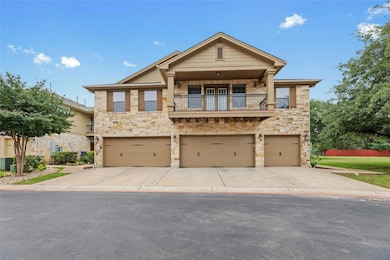 View of front of house featuring a balcony, an at