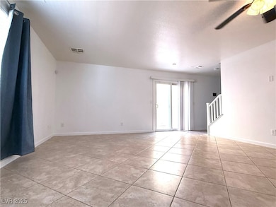 Unfurnished room featuring a ceiling fan, light ti