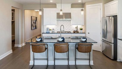Kitchen with a kitchen island with sink, baseboar