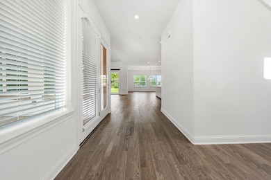 Hall with dark wood finished floors, baseboards, 