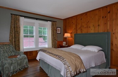 Guest Bedroom: Upstairs, the pine-paneled Guest Be