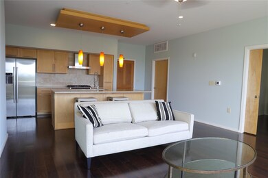 Living area featuring dark wood finished floors, a ceiling fan, and recessed lighting