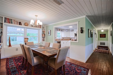 Dining area with a chandelier, ornamental molding