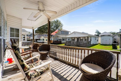 Wooden terrace featuring ceiling fan