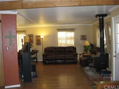 Family room is large with laminate wood flooring. 