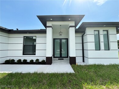 Property entrance featuring french doors and stucc