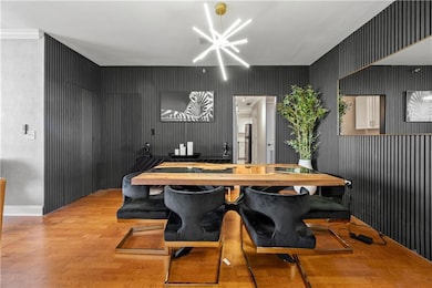 Dining Room with fluted wood wall and hidden door.