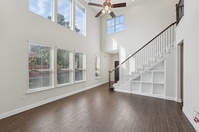 Unfurnished living room with ceiling fan, a high 