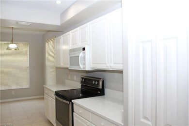 Kitchen with white cabinets, stainless steel elect