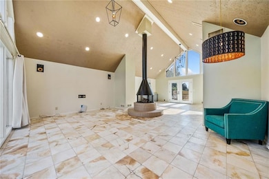 Living room with high vaulted ceiling and a wood b