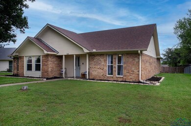 Single story home featuring brick siding and a shi
