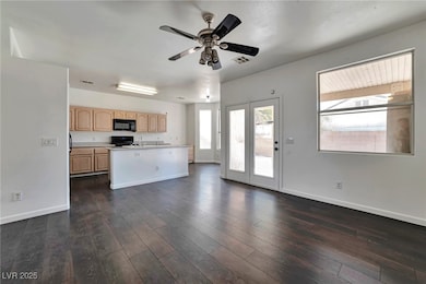 Kitchen featuring black appliances, light brown ca
