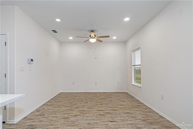 Unfurnished room with ceiling fan and light wood-type flooring