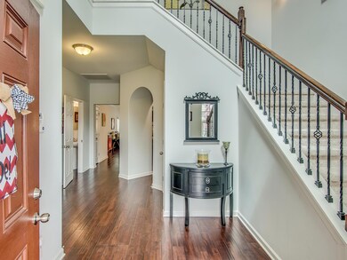 Come on in! Hardwood floors, wrought iron railing and a two story foyer. 
