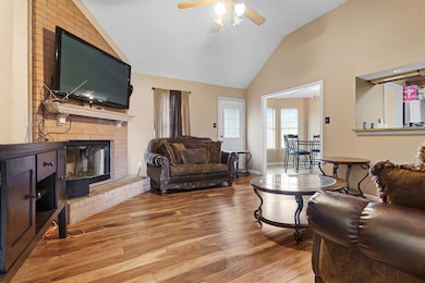 Living room with a textured ceiling, lofted ceilin